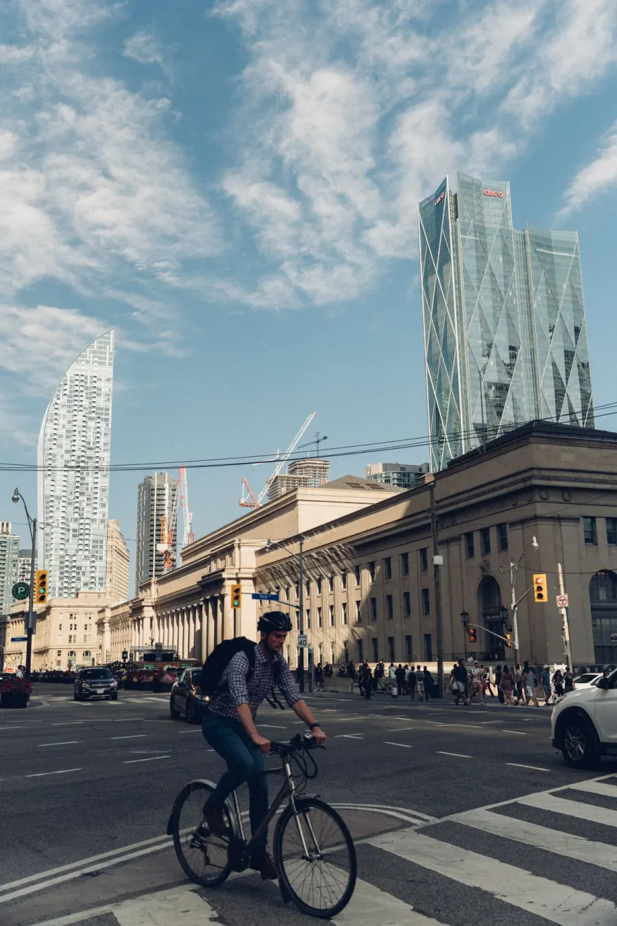 A cyclist riding through a city intersection.